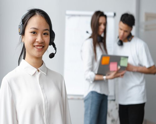 friendly indonesian customer support representative smiling in office